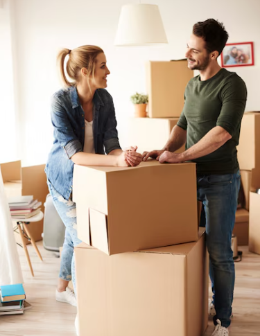 A happy couple packing boxes for their move in Greensboro, North Carolina.